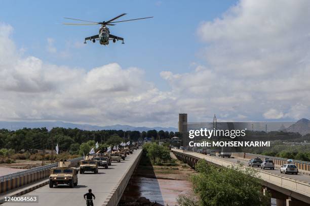 Taliban fighters in armoured vehicles take part in a military street parade in Herat on April 19, 2022.