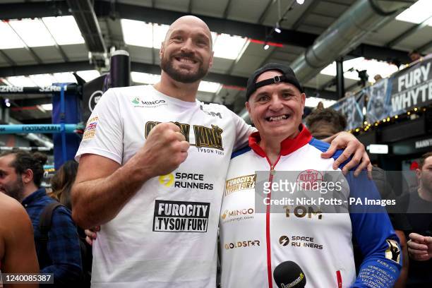 Tyson Fury with father and trainer John Fury after an open workout at BOXPARK Wembley, London. Picture date: Tuesday April 19, 2022.