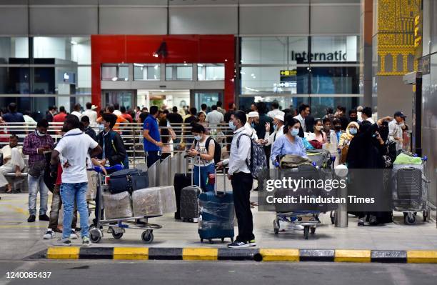 Passengers wait for taxi at Terminal 3, Indira Gandhi International Airport on April 18, 2022 in New Delhi, India. Several unions of auto rickshaw,...