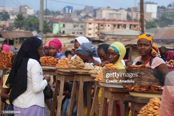 Female street vendors are seen with traditional food they prepared during the holy month of Ramadan at a market area in Yaounde, Cameroon on April...