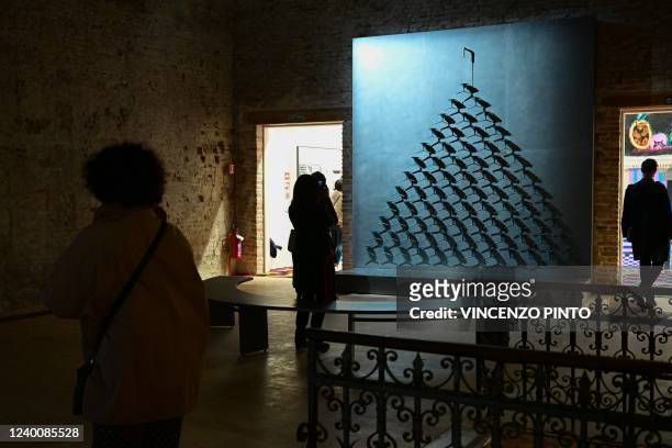 Visitors view photo of 'Fountain of Exhaustion' by artist Pavlo Makov at Ukraine's pavilion, on a press day ahead of the 59th Venice Art Biennale in...