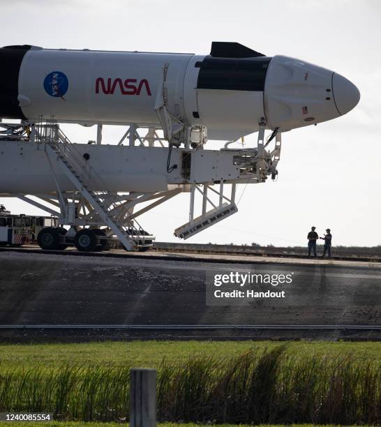 In this handout photo provided by NASA, a SpaceX Falcon 9 rocket with the company's Crew Dragon spacecraft onboard is seen as it is rolled out to the...