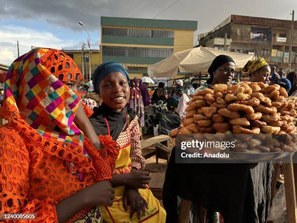 Female street vendors are seen with traditional food they prepared during the holy month of Ramadan at a market area in Yaounde, Cameroon on April...