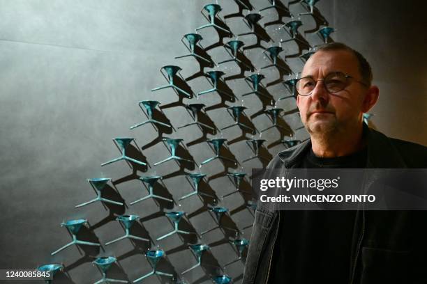 Ukrainian artist Pavlo Makov poses by his piece 'Fountain of Exhaustion' at Ukraine's pavilion during a press day at the 59th Venice Art Biennale in...