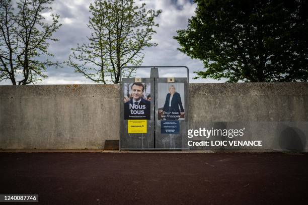 Photograph shows electoral campaign posters of France's President and La Republique en Marche candidate for re-election Emmanuel Macron and France's...