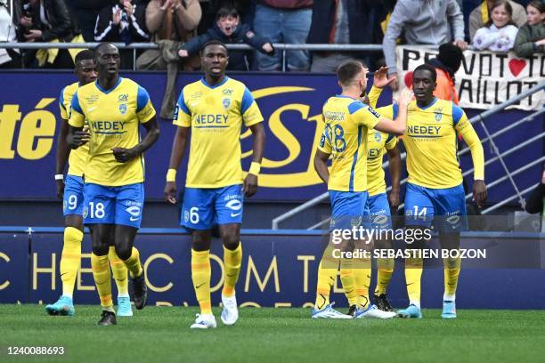 Sochaux French midfielder Rassoul Ndiaye celebrates with teammates after scoring a goal during the French L2 football match between FC...
