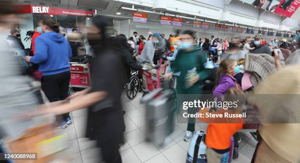 Passengers wait to be allowed onto their Sunwing flights after some have been delayed over a day at Toronto Pearson International Airport in...