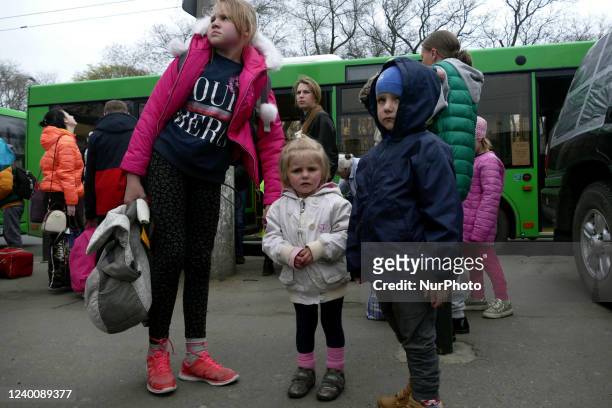 Children stand before a bus as 300 Mykolaiv residents - mostly women, children and disabled people - come to Odesa, southern Ukraine.