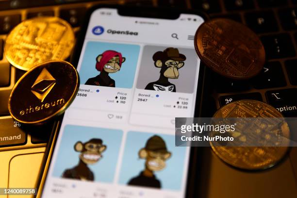 Bored Ape Yacht Club collection in OpenSea displayed on a phone screen, representation of cryptocurrencies and a laptop keyboard are seen in this...