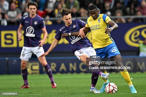 Sochaux Congolese French forward Yann Kitala fights for the ball with Toulouses Australian midfielder Denis Genreau during the French L2 football...