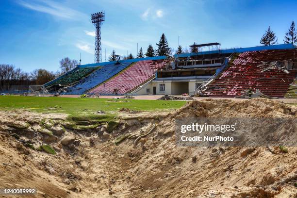 Huge crater caused by Russian shelling remains on the pitch of the Chernihiv Olympic Sports Training Centre , Chernihiv, northern Ukraine.