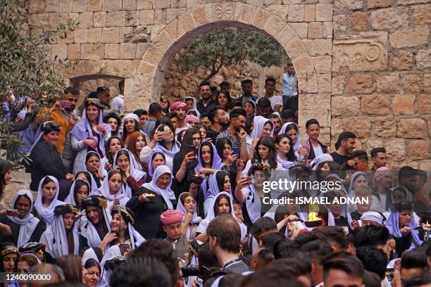 Iraqi Yazidis gather outside the Temple of Lalish in a valley near the Kurdish city of Dohuk on April 19 during a ceremony marking the Yazidi New...