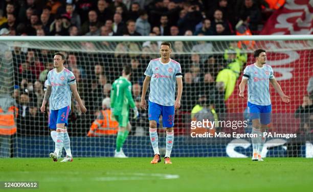 Manchester United's Phil Jones, Nemanja Matic and Harry Maguire look dejected after Liverpool's Luis Diaz scores their side's first goal of the game...