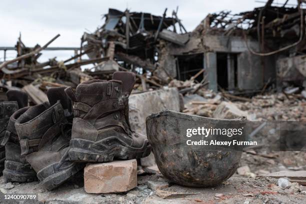 Boots and helmets belonging to Ukrainian military that were stationed at a bread factory bombed by the Russians are left behind on April 19, 2022 in...