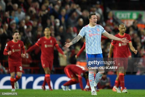 Manchester United's English defender Phil Jones reacts after Liverpool's Egyptian midfielder Mohamed Salah scored his team second goal during the...