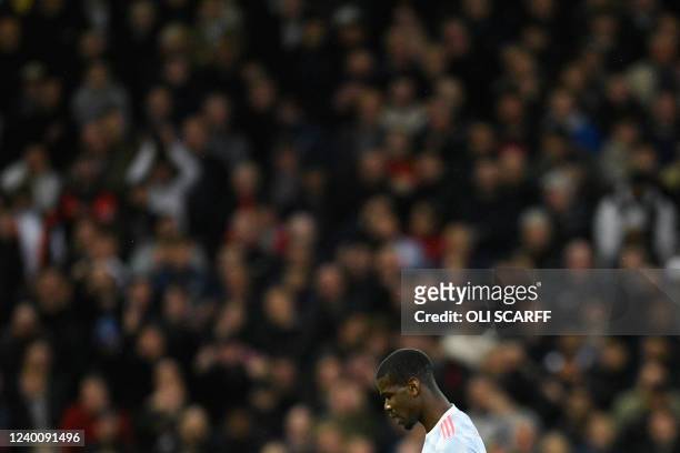 Manchester United's French midfielder Paul Pogba reacts during the English Premier League football match between Liverpool and Manchester United at...