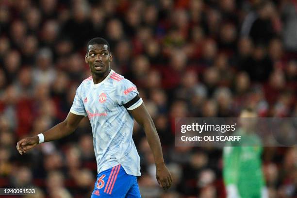 Manchester United's French midfielder Paul Pogba reacts during the English Premier League football match between Liverpool and Manchester United at...