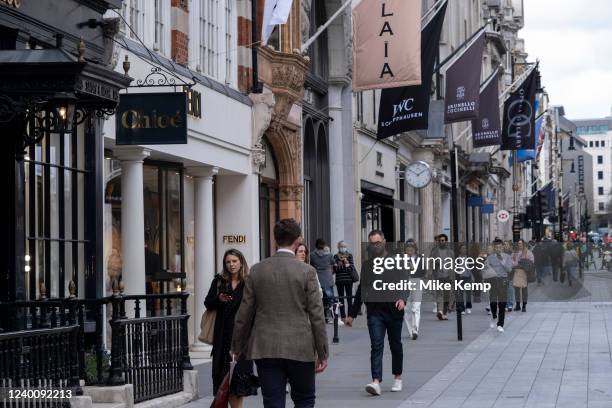 People on Bond Street on 13th April 2022 in London, United Kingdom. Bond Street is one of the principal streets in the West End shopping district and...