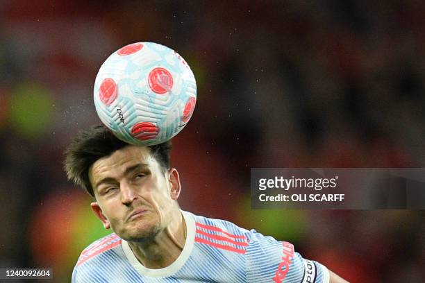 Manchester United's English defender Harry Maguire eyes the ball during the English Premier League football match between Liverpool and Manchester...