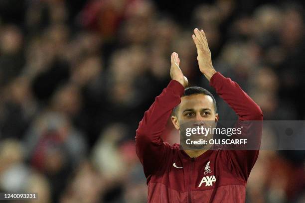 Liverpool's Spanish midfielder Thiago Alcantara applauds at the end of the English Premier League football match between Liverpool and Manchester...
