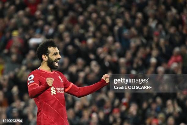 Liverpool's Egyptian midfielder Mohamed Salah celebrates after scoring his team fourth goal during the English Premier League football match between...