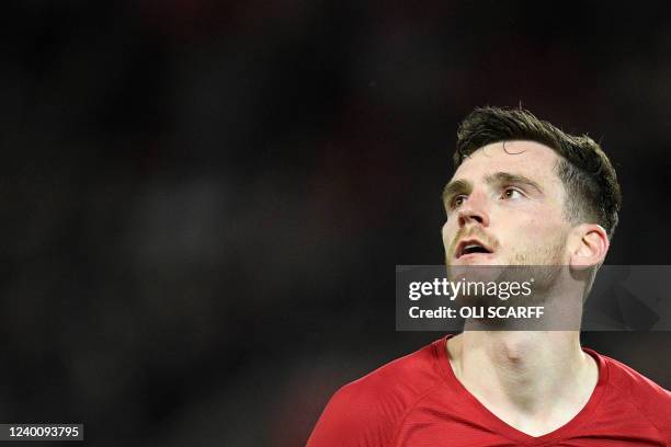 Liverpool's Scottish defender Andrew Robertson celebrates at the end of the English Premier League football match between Liverpool and Manchester...