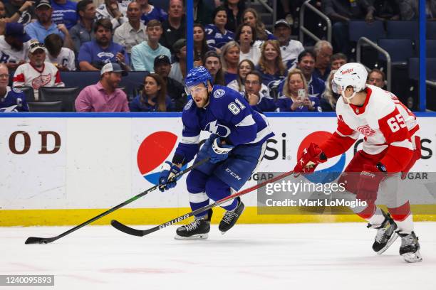 Erik Cernak of the Tampa Bay Lightning skates against Danny DeKeyser of the Detroit Red Wings during the first period at Amalie Arena on April 19,...