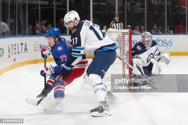 Frank Vatrano of the New York Rangers skates for the puck against Adam Lowry of the Winnipeg Jets at Madison Square Garden on April 19, 2022 in New...