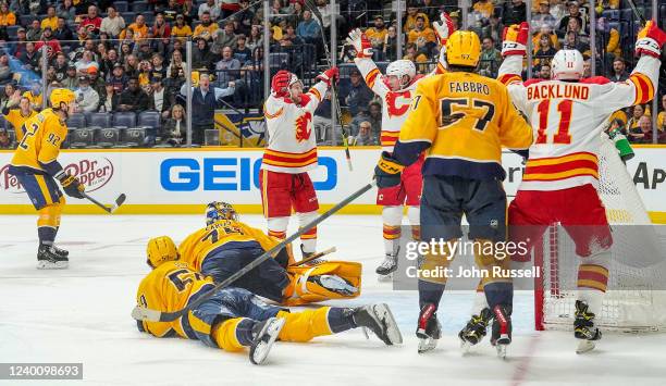 Andrew Mangiapane celebrates his goal with Tyler Toffoli of the Calgary Flames against the Nashville Predators during an NHL game at Bridgestone...