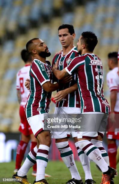 Paulo Henrique Ganso of Fluminense celebrates with teammates Samuel and Willian Bigode after scoring during a first leg quarter final match of Copa...