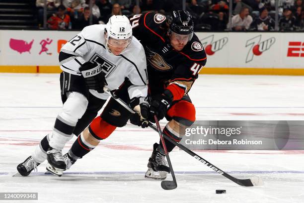 Trevor Moore of the Los Angeles Kings battles for the puck against Max Comtois of the Anaheim Ducks during the game at Honda Center on April 19, 2022...