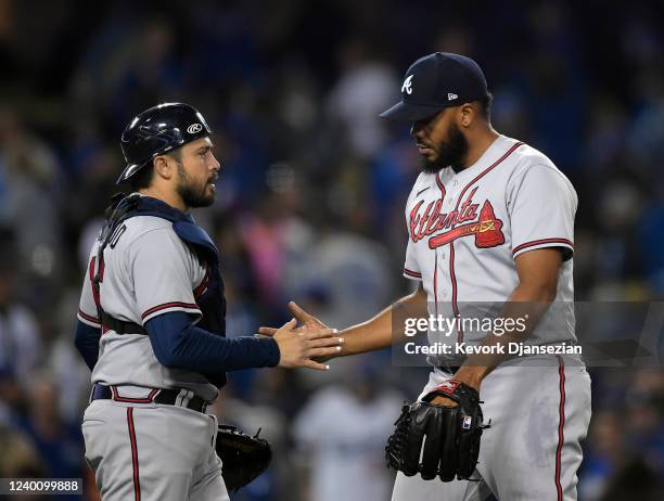 Closer Kenley Jansen of the Atlanta Braves celebrates with catcher Travis d'Arnaud after closing out the game against the Los Angeles Dodgers at...