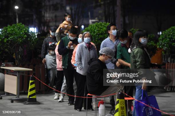 Residents line up for the Covid-19 test in Wuhan in central China's Hubei province Tuesday, April 19, 2022. A negative SARS-Cov-2 test result within...