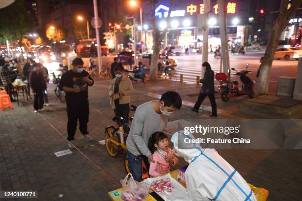 Medical worker takes swab samples on residents for the Covid-19 test in Wuhan in central China's Hubei province Tuesday, April 19, 2022. A negative...