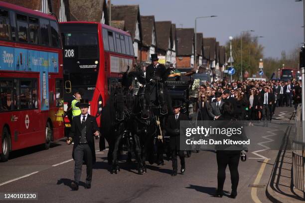 Horse-drawn hearse leads a procession through Orpington before a funeral service for Tom Parker at St Francis of Assisi church on April 20, 2022 in...