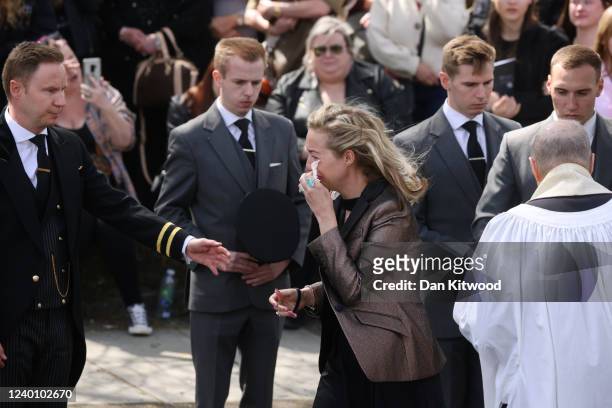 Wife of Tom Parker, Kelsey Parker , reacts as the coffin is carried from St Francis of Assisi church and lowered into a hearse following a funeral...