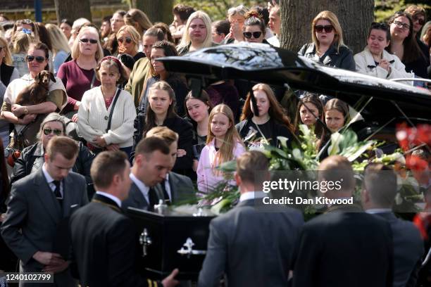 The coffin is carried from St Francis of Assisi church and lowered into a hearse following a funeral service for Tom Parker on April 20, 2022 in...