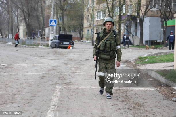 Russian military members patrol in the Ukrainian city of Mariupol under the control of Russian military and pro-Russian separatists, on April 19,...