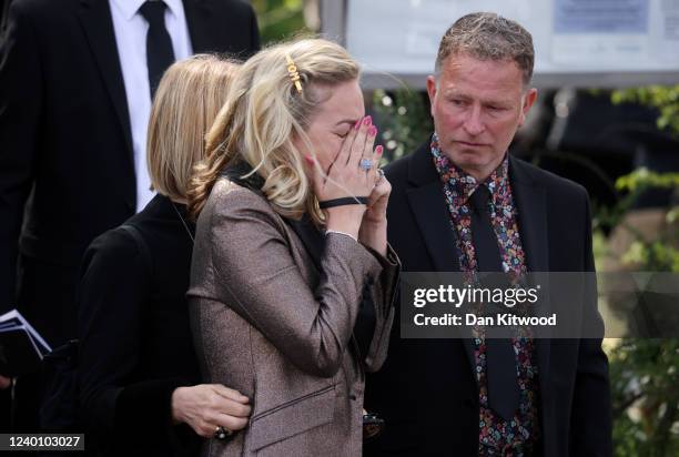 Wife of Tom Parker, Kelsey Parker , reacts as the coffin is carried from St Francis of Assisi church and lowered into a hearse following a funeral...