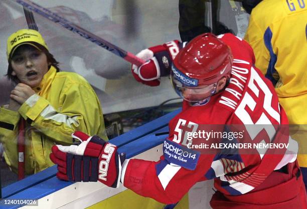 Arena staffer reacts as Russian Andrey Markov is being smashed during the preliminary round group D game of the IIHF Internetional Ice Hockey World...