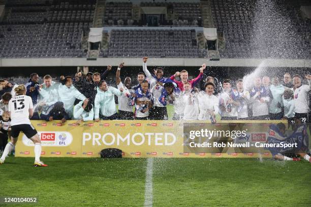 Fulham players celebrate promotion during the Sky Bet Championship match between Fulham and Preston North End at Craven Cottage on April 18, 2022 in...