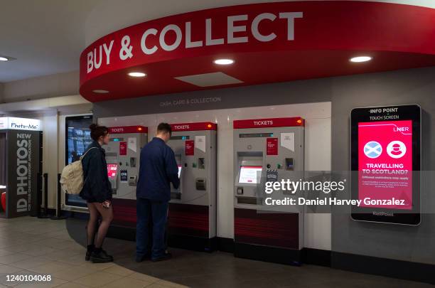 Young man and woman purchase train tickets at a digital ticket kiosk provided by LNER as the government's Transport Secretary announces the Great...