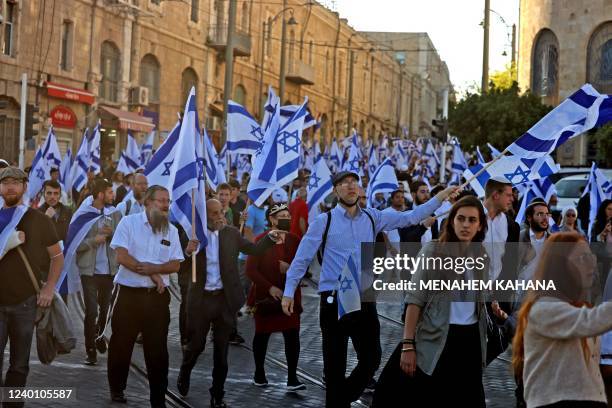 Israeli protesters wave national flags as they march toward Tzahal square on April 20 during the 'flags march' organised by nationalist parties.