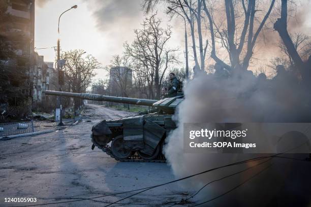 Donetsk People's Republic tank lets out a cloud of diesel smoke as it proceeds towards the Azovstal frontline in Mariupol. The battle between Russian...