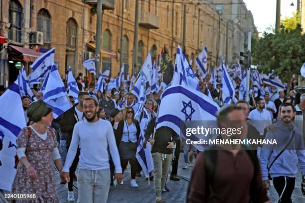 Israeli protesters wave national flags as they march toward Tzahal square on April 20 during the 'flags march' organised by nationalist parties.