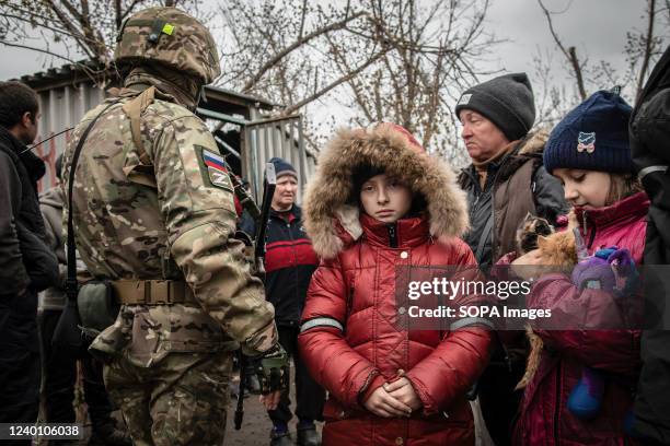 Girl in Mariupol holds two kittens as she and her family prepare to leave their bombshelter in Eastern Mariupol for the first time in over a month....