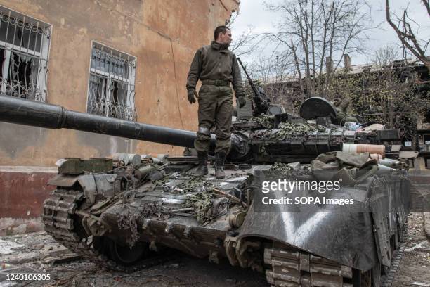 Russian soldier stands atop hit T-80 MBT in a position close to Mariupol's embattled Azovstal plant as his unit prepares for an assault. The battle...