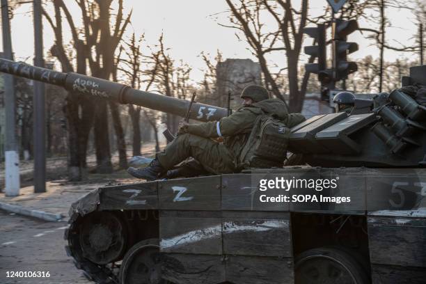 Russian soldiers seen sitting on a T-80 tank heading towards the Azovstal plant- one of the final pockets of Ukrainian resistance. The battle between...