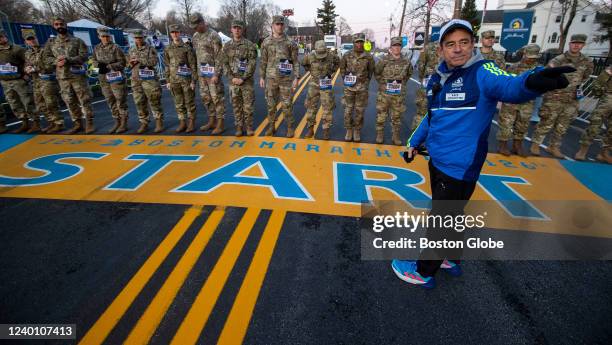 Hopkinton, MA Dave McGillivray, race director of the Boston Marathon, sends the military march division off at 6AM in Hopkinton, MA on March 18, 2022.