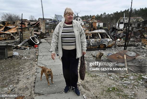 Natalia stands in front of her destroyed house in the village of Moshchun, northwest of Kyiv, on April 20 as more than five million Ukrainians have...